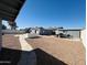 Wide-angle view of a gravel backyard with concrete path and block wall for added privacy at 4836 W Redfield Rd, Glendale, AZ 85306