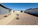 Large gravel backyard with a concrete patio and block wall fencing ensuring privacy at 4836 W Redfield Rd, Glendale, AZ 85306