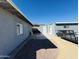 Side yard featuring gravel ground cover, block wall fencing, and storage buildings at 4836 W Redfield Rd, Glendale, AZ 85306