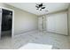 Bedroom featuring marble flooring, closet, ceiling fan, and access to bathroom at 4836 W Redfield Rd, Glendale, AZ 85306