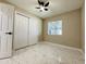 Bedroom with fan, window, closet, and flooring with a marble effect at 4836 W Redfield Rd, Glendale, AZ 85306