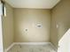 Clean, blank laundry room with tile floors and washer and dryer hook-ups ready to be installed at 4836 W Redfield Rd, Glendale, AZ 85306