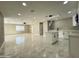 Bright, open-concept living room and kitchen featuring marble floors and modern white cabinetry at 4836 W Redfield Rd, Glendale, AZ 85306