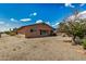 Spacious backyard with desert landscaping featuring a covered patio area at 485 S Pino Cir, Apache Junction, AZ 85120