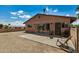 Covered patio area with desert landscaping and sitting chairs in a fenced yard at 485 S Pino Cir, Apache Junction, AZ 85120