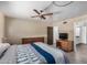 The bedroom features a ceiling fan, a dresser, and a view to the bathroom at 485 S Pino Cir, Apache Junction, AZ 85120