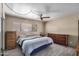 Cozy bedroom with a large window and a ceiling fan, offering a relaxing space to unwind and rest at 485 S Pino Cir, Apache Junction, AZ 85120