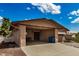 Attached carport offers shade and protection from the elements, with an entrance door on the side of the building at 485 S Pino Cir, Apache Junction, AZ 85120