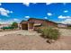 A tan single-story home featuring a front carport, low maintenance desert landscape and ample front yard space at 485 S Pino Cir, Apache Junction, AZ 85120