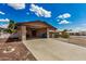 Attached carport offers shade and protection from the elements, with an entrance door on the side of the building at 485 S Pino Cir, Apache Junction, AZ 85120