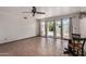 Living room featuring tile floors, a ceiling fan, and sliding glass doors to the backyard at 485 S Pino Cir, Apache Junction, AZ 85120