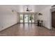 Bright living room featuring tile floors, a ceiling fan, and sliding glass doors to the backyard at 485 S Pino Cir, Apache Junction, AZ 85120