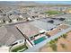 Aerial view of a home with a pool and desert landscaping in a vibrant residential community at 5121 N 181St Dr, Litchfield Park, AZ 85340