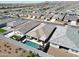 Aerial view of a home featuring a backyard pool, desert landscaping, and neighborhood homes at 5121 N 181St Dr, Litchfield Park, AZ 85340