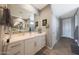 Spacious bathroom featuring dual sinks, white cabinets, and tile floors at 5121 N 181St Dr, Litchfield Park, AZ 85340