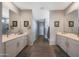 Bright bathroom featuring dual sinks, white cabinets, and tile floors at 5121 N 181St Dr, Litchfield Park, AZ 85340