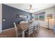 An open dining room features a wooden table, white chairs, tile floor, and a blue accent wall at 5121 N 181St Dr, Litchfield Park, AZ 85340