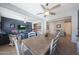 A dining room open to the living room has a wooden table and chairs, and a blue accent wall at 5121 N 181St Dr, Litchfield Park, AZ 85340