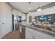 Modern kitchen with stainless steel appliances and large island, open to the living area at 5121 N 181St Dr, Litchfield Park, AZ 85340