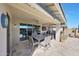 Covered patio featuring a dining set and a view of the backyard pool at 5121 N 181St Dr, Litchfield Park, AZ 85340