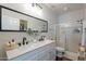 Modern bathroom features dual sinks, quartz countertops, and a glass-enclosed shower at 525 N Miller Rd # 122, Scottsdale, AZ 85257