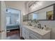 This modern bathroom features dual sinks and is situated near the bedroom and walk-in closet at 525 N Miller Rd # 122, Scottsdale, AZ 85257