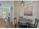 Comfortable dining area with natural light, a modern chandelier, and an adjacent living room at 525 N Miller Rd # 122, Scottsdale, AZ 85257