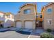 Two-story townhome with a two-car garage, clean driveway and walkway in a community setting at 525 N Miller Rd # 122, Scottsdale, AZ 85257