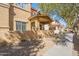 Exterior view showcases a residential building with covered patios, desert landscaping, and a pedestrian walkway at 525 N Miller Rd # 122, Scottsdale, AZ 85257