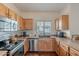 Well-equipped kitchen features stainless steel appliances and wood cabinets at 525 N Miller Rd # 122, Scottsdale, AZ 85257