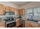 Well-equipped kitchen features stainless steel appliances and wood cabinets at 525 N Miller Rd # 122, Scottsdale, AZ 85257