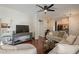 Spacious living room featuring hardwood floors, neutral colors, and modern ceiling fan at 525 N Miller Rd # 122, Scottsdale, AZ 85257