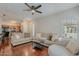 Bright living room featuring hardwood floors, modern ceiling fan, and comfortable neutral furniture at 525 N Miller Rd # 122, Scottsdale, AZ 85257