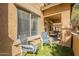 Inviting outdoor patio area featuring chairs, artificial grass, and a lovely community view at 525 N Miller Rd # 122, Scottsdale, AZ 85257