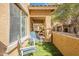 Outdoor patio space with artificial grass, seating area, and a view of the surrounding residential neighborhood at 525 N Miller Rd # 122, Scottsdale, AZ 85257