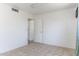 Clean bedroom with tile flooring and white walls, featuring a doorway and a corner wall heater at 5907 N Azalia St, Casa Grande, AZ 85122