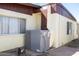 Exterior view of an HVAC system, showing the unit's placement and brick foundation of the home at 5907 N Azalia St, Casa Grande, AZ 85122