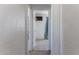 Hallway leading to a bathroom with tile flooring and neutral walls, showing a practical layout at 5907 N Azalia St, Casa Grande, AZ 85122