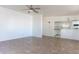 A large, naturally well-lit living room featuring tile flooring and a ceiling fan at 5907 N Azalia St, Casa Grande, AZ 85122