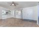 A large, naturally well-lit living room featuring tile flooring with a door to the outside at 5907 N Azalia St, Casa Grande, AZ 85122