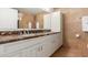 Modern bathroom featuring a double vanity with marble countertops and light travertine walls at 7161 E Rancho Vista Dr # 2015, Scottsdale, AZ 85251