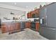 Modern kitchen with stainless steel appliances, tile floors, and wood cabinetry at 8176 S Pioneer Ct, Gold Canyon, AZ 85118