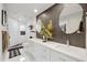 Elegant bathroom with a double sink vanity, decorative mirrors, white cabinets, and tile flooring at 8653 E Royal Palm Rd # 1033, Scottsdale, AZ 85258