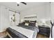 Modern bedroom with a bed and a sliding barn door entrance to the bathroom at 8653 E Royal Palm Rd # 1033, Scottsdale, AZ 85258