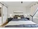 Well-lit bedroom with a bed and a sliding barn door entrance to a bathroom at 8653 E Royal Palm Rd # 1033, Scottsdale, AZ 85258