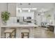 Modern kitchen with white cabinets, stainless steel appliances, and a breakfast bar with seating at 8653 E Royal Palm Rd # 1033, Scottsdale, AZ 85258