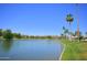 Picturesque pond reflecting lush greenery and clear blue sky, creating a serene landscape on a clear day at 8653 E Royal Palm Rd # 1033, Scottsdale, AZ 85258