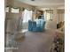 Traditional dining room with glass table, blue chairs, and bright, natural light at 901 W Oriole Way, Chandler, AZ 85286