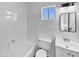 Bright bathroom featuring a tub, white vanity, toilet, and a window at 909 W Danbury Rd, Phoenix, AZ 85023