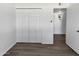 Bedroom featuring wood-look floors and double door closet at 909 W Danbury Rd, Phoenix, AZ 85023